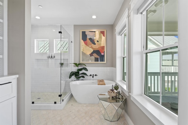 bathroom with separate shower and tub and tile patterned floors