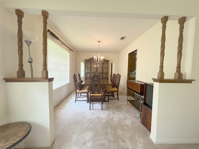 dining space with a notable chandelier and carpet