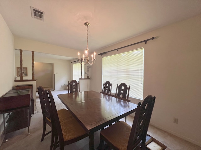 carpeted dining space featuring a notable chandelier