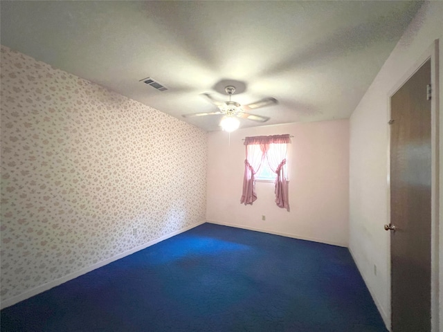 spare room with carpet floors and ceiling fan