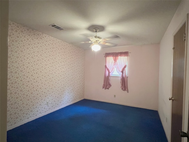 carpeted empty room featuring ceiling fan