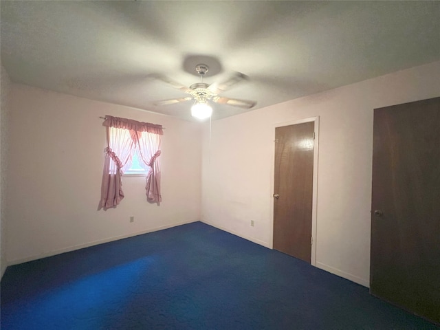 spare room with carpet and ceiling fan