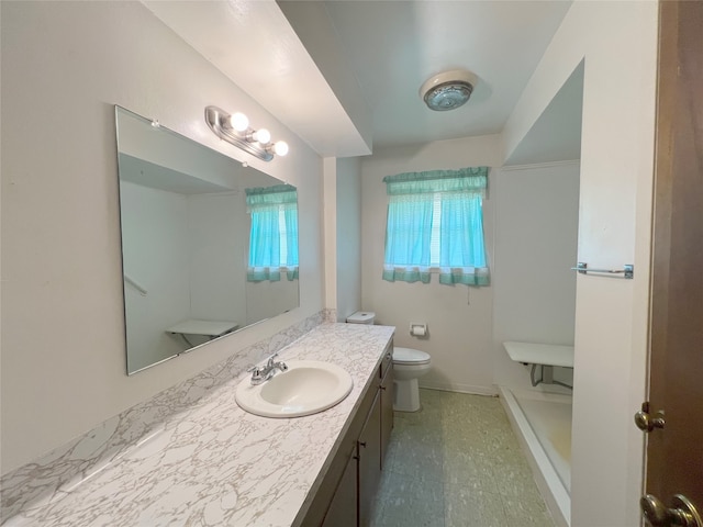 bathroom featuring tile floors, toilet, and vanity with extensive cabinet space