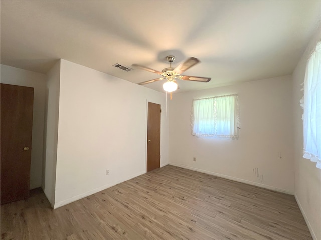 spare room featuring wood-type flooring and ceiling fan