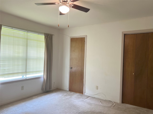 unfurnished bedroom featuring carpet and ceiling fan