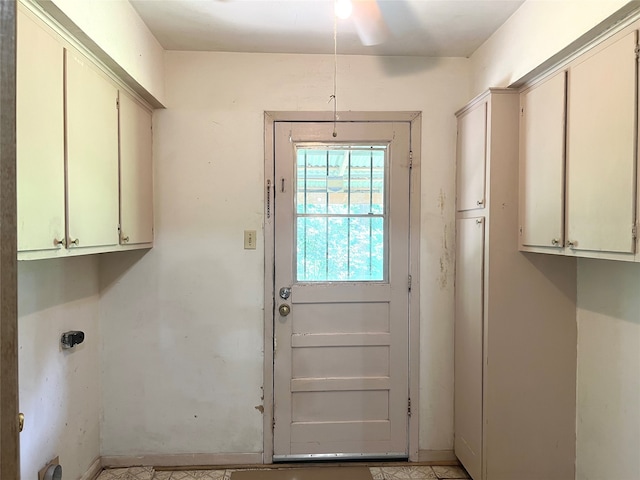 doorway to outside with ceiling fan and light tile floors