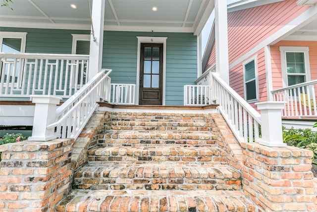 view of exterior entry featuring a porch