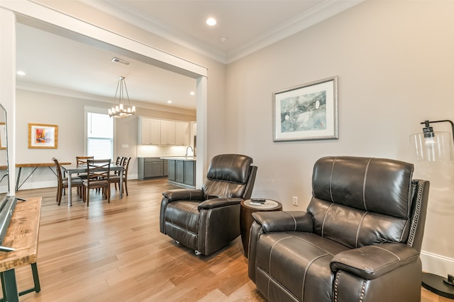 interior space featuring a notable chandelier, sink, light hardwood / wood-style floors, and crown molding