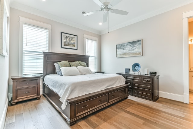 bedroom with ceiling fan, connected bathroom, light wood-type flooring, and ornamental molding