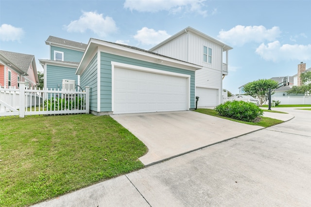 view of front of home featuring a front yard and a garage