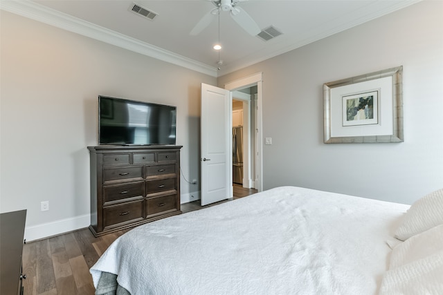 bedroom with dark hardwood / wood-style flooring, ornamental molding, and ceiling fan