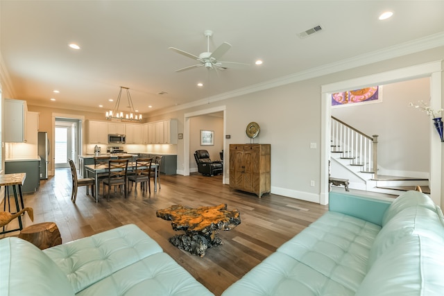 living room with ceiling fan, crown molding, and hardwood / wood-style flooring