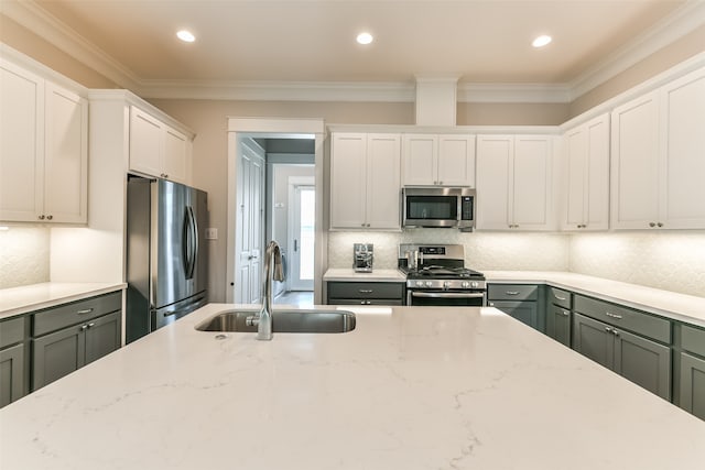 kitchen featuring white cabinetry, stainless steel appliances, crown molding, and sink