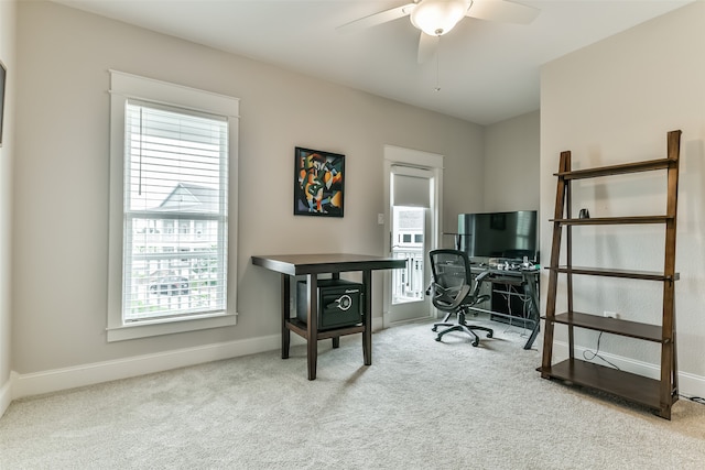 home office with ceiling fan and light carpet