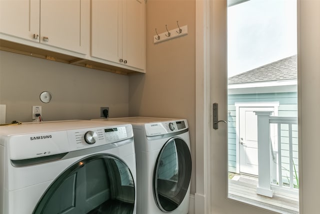 laundry area with cabinets, hookup for an electric dryer, and washing machine and dryer