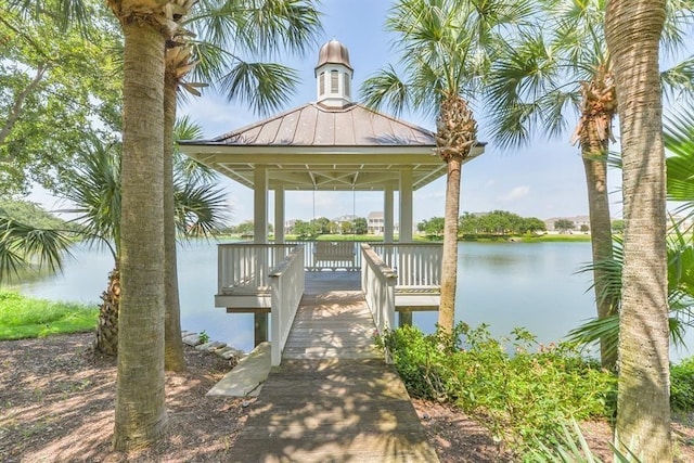 view of dock with a gazebo and a water view