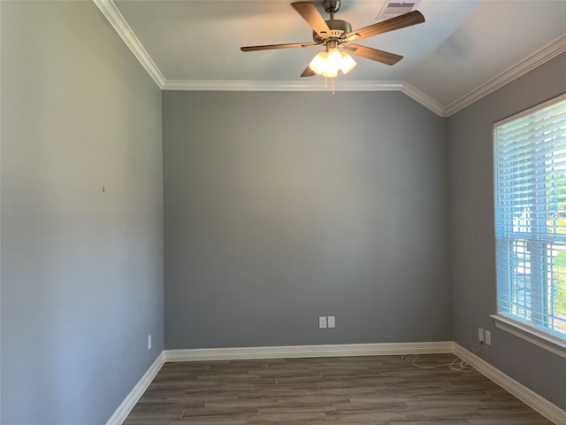 empty room with ceiling fan, vaulted ceiling, hardwood / wood-style flooring, and crown molding