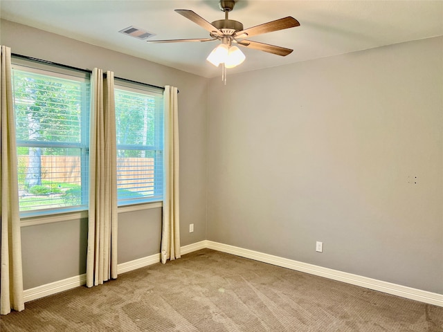 carpeted empty room featuring ceiling fan