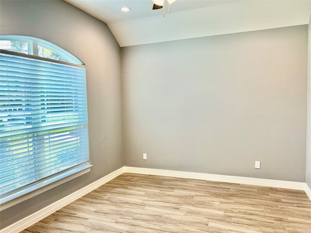 unfurnished room with ceiling fan, light wood-type flooring, and lofted ceiling