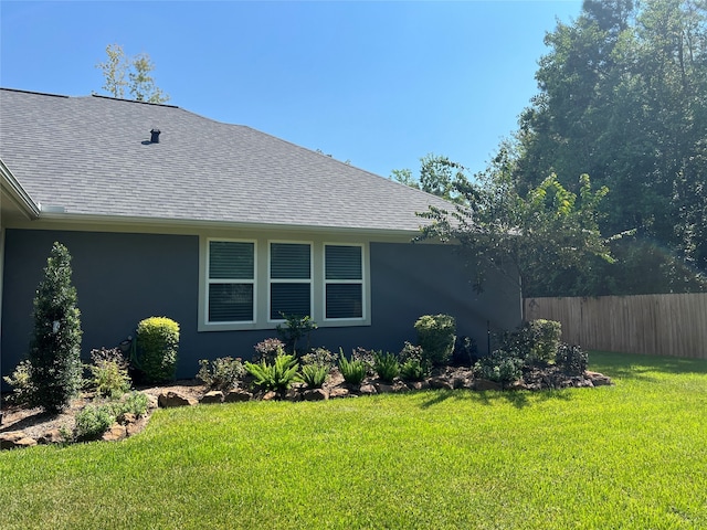 view of side of home with a lawn