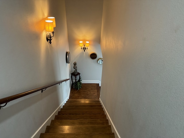 stairs with dark wood-type flooring