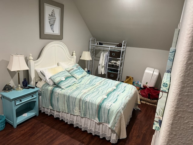 bedroom featuring hardwood / wood-style flooring and lofted ceiling