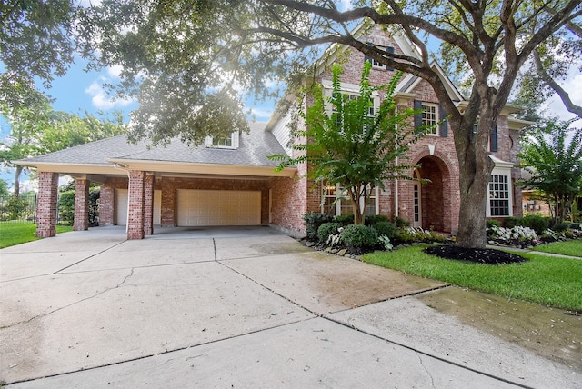 view of front of property featuring a carport, a garage, and a front lawn