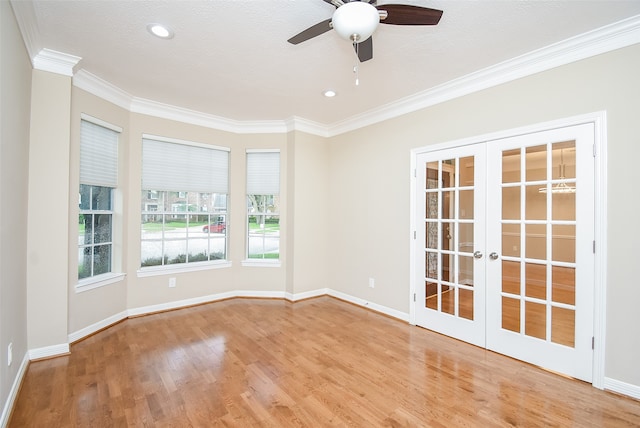 spare room with light wood-type flooring, crown molding, a textured ceiling, ceiling fan, and french doors