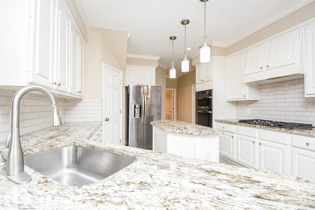 kitchen with sink, tasteful backsplash, a kitchen island, white cabinetry, and appliances with stainless steel finishes