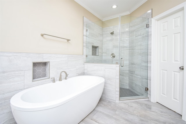 bathroom with tile walls, crown molding, and separate shower and tub