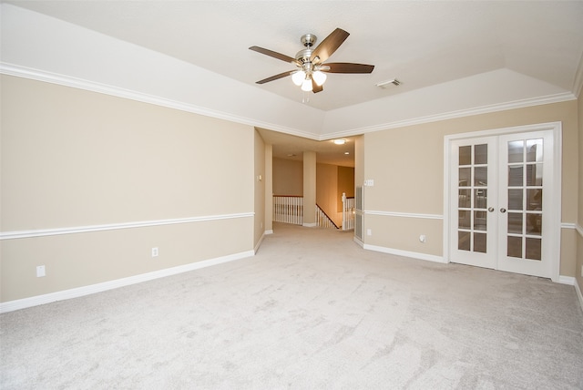 carpeted spare room featuring ceiling fan, a raised ceiling, french doors, and crown molding