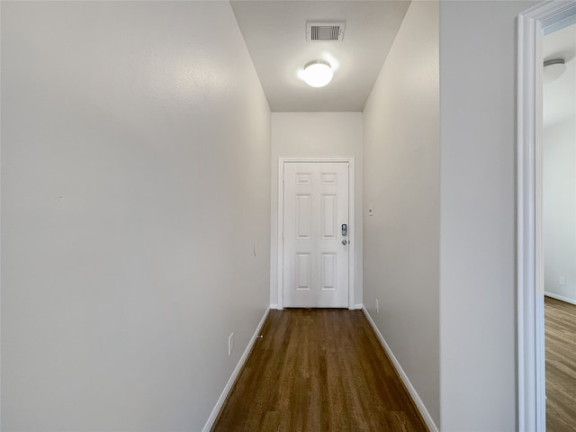 hallway with hardwood / wood-style flooring