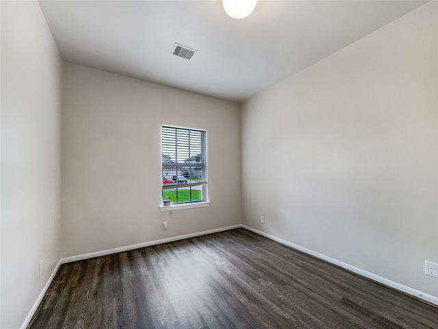 unfurnished room featuring dark wood-type flooring