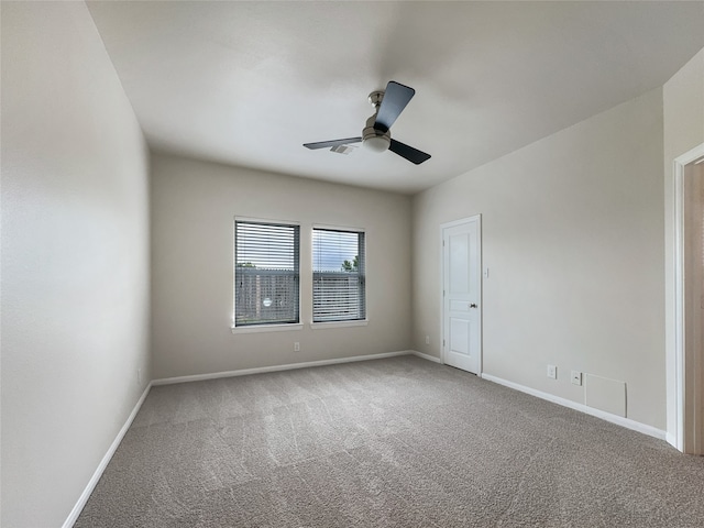 empty room featuring carpet flooring and ceiling fan