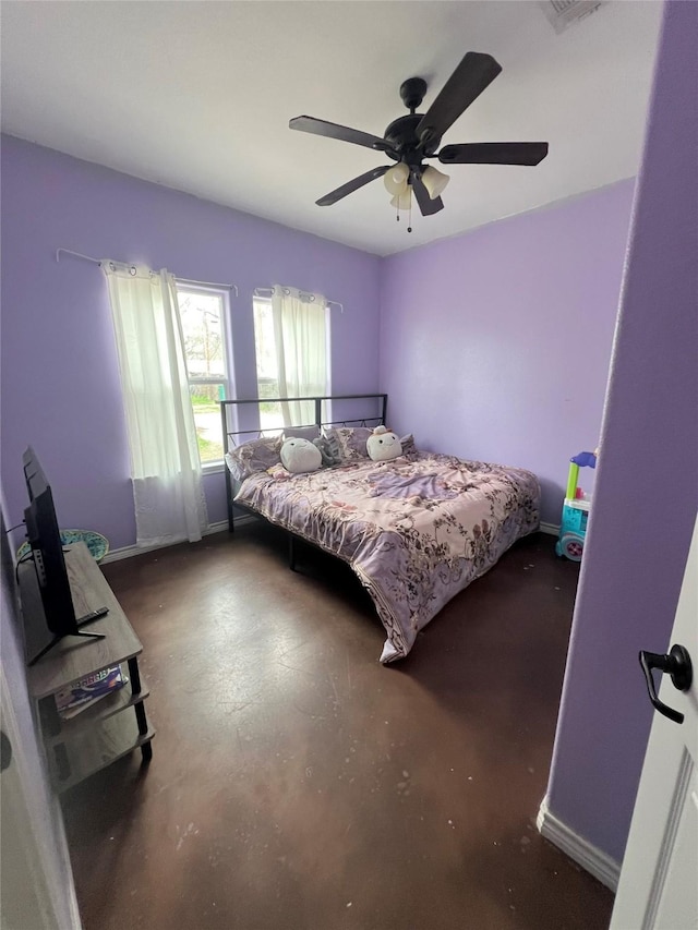 bedroom with baseboards, concrete flooring, and a ceiling fan