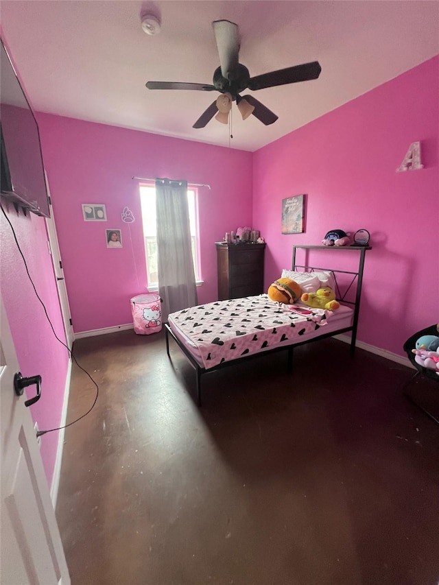 bedroom featuring baseboards, concrete flooring, and ceiling fan