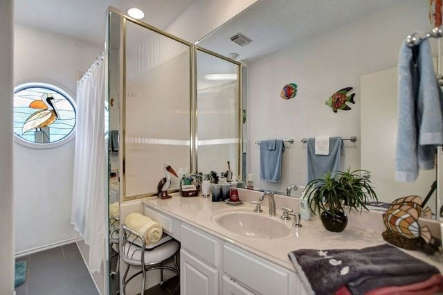 bathroom featuring tile floors and oversized vanity