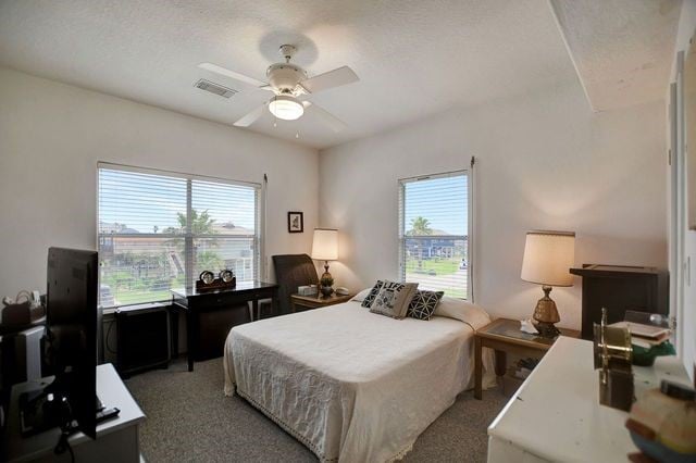 bedroom featuring ceiling fan and carpet floors