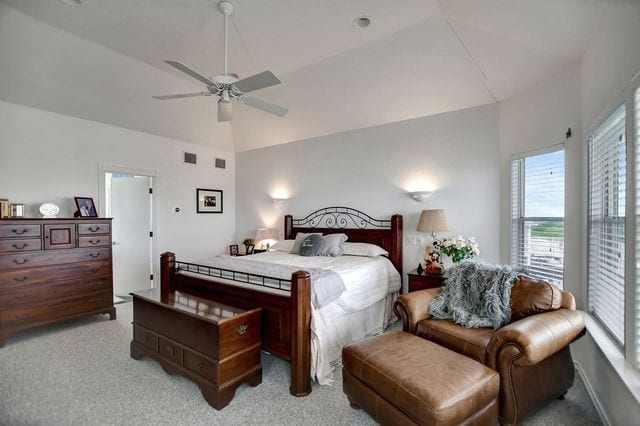 carpeted bedroom with vaulted ceiling and ceiling fan