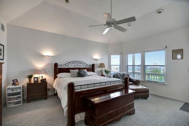 carpeted bedroom with ceiling fan and lofted ceiling