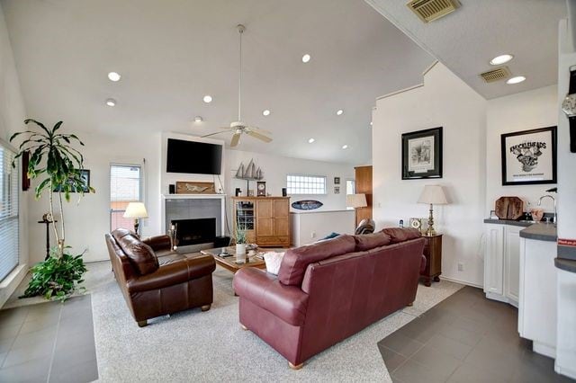 tiled living room featuring ceiling fan