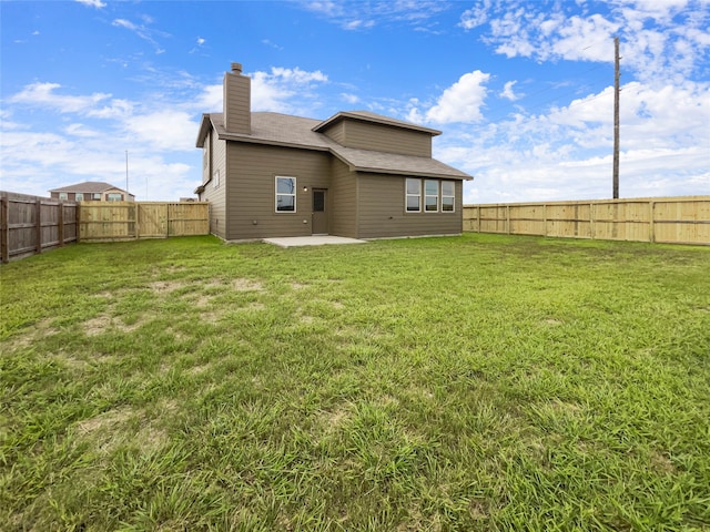 back of property featuring a lawn and a patio