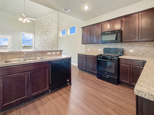 kitchen featuring light hardwood / wood-style floors, black appliances, backsplash, sink, and ceiling fan