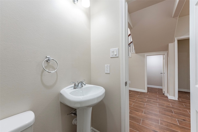 bathroom with vaulted ceiling, toilet, and tile floors