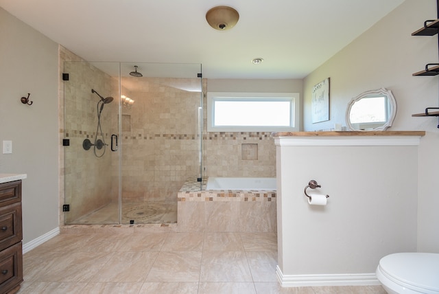 full bathroom featuring tile floors, independent shower and bath, vanity, and toilet