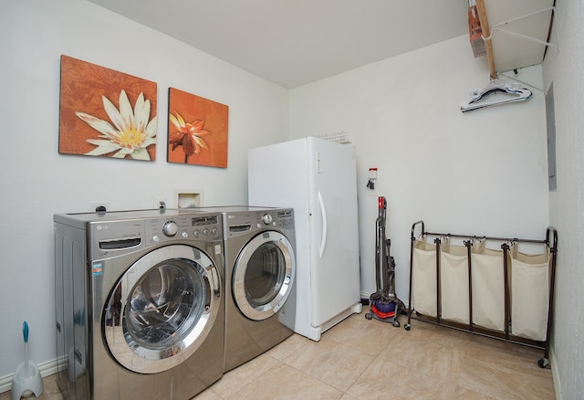 laundry area with washer and clothes dryer, washer hookup, and light tile floors