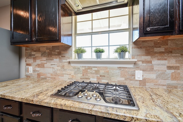 kitchen featuring dark brown cabinets, tasteful backsplash, and stainless steel gas cooktop