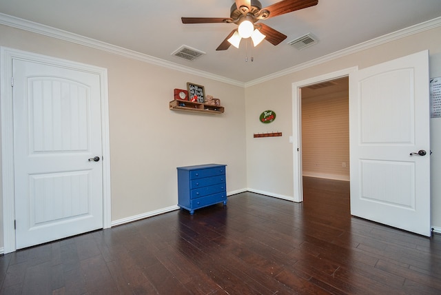 empty room with dark hardwood / wood-style floors, ceiling fan, and crown molding