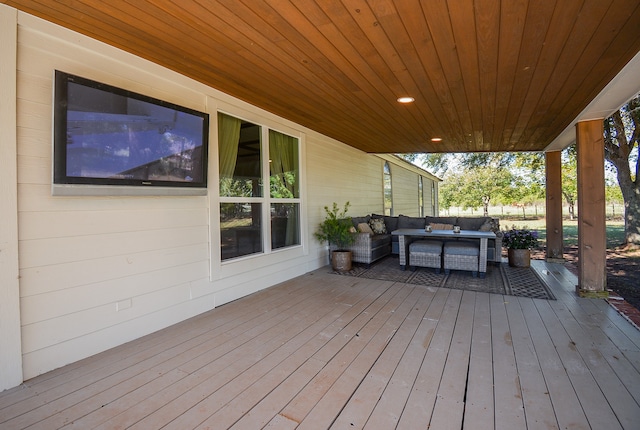 wooden terrace with an outdoor hangout area