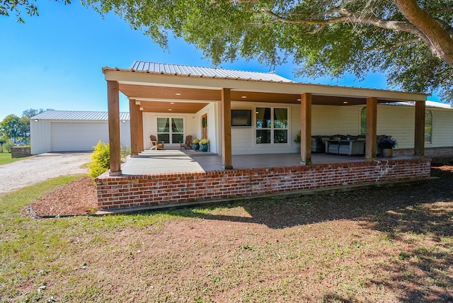 view of front of property featuring a garage and an outdoor structure